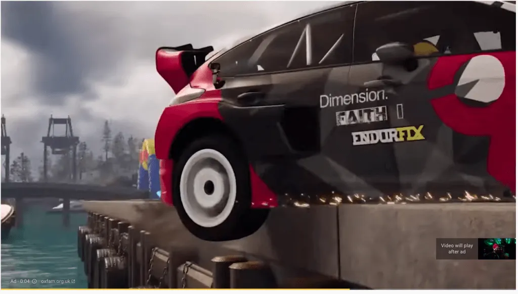 Red car sitting on edge of bridge